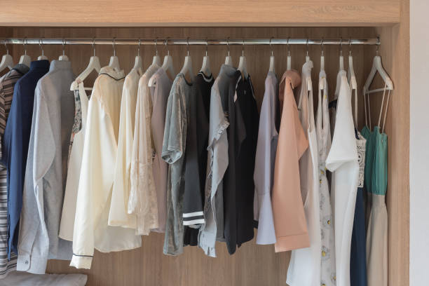 istock wooden closet with clothes hanging 908593424