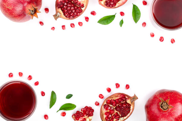 istock pomegranate juice with fresh pomegranate fruits isolated on white background with copy space for your text. Top view 908596922