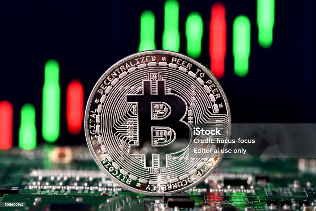 Bitcoin İstanbul, Turkey - January 21, 2018: Close up shot of bitcoin memorial coins on a screen displaying a financial chart. Bitcoin is a crypto currency and a worldwide payment system. Bitcoin Stock Photo