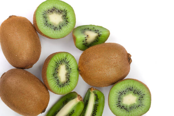 istock Kiwi fruit with slices isolated on white background, close-up. Top view. Flat lay pattern 908600612