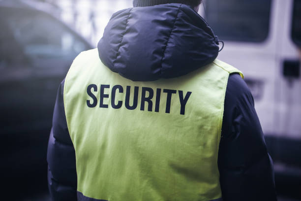 istock security guard team is working in street for safety. guard appreance from behind. 908600734