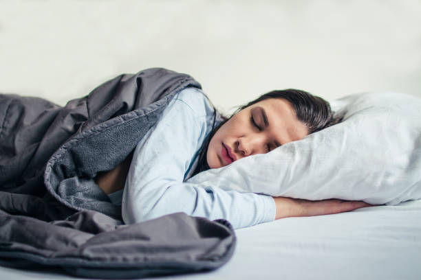 istock Young beautiful woman sleeping in her bed 908600818