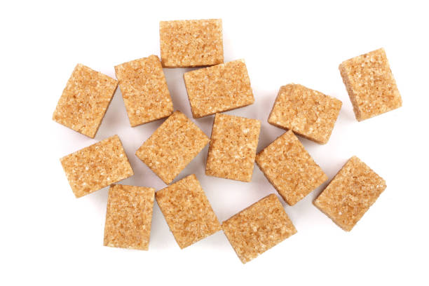 istock brown sugar cubes isolated on white background. Top view. Flat lay 908603910