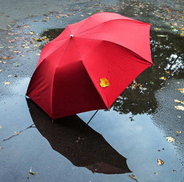 istock Red umbrella on a street. 908603952