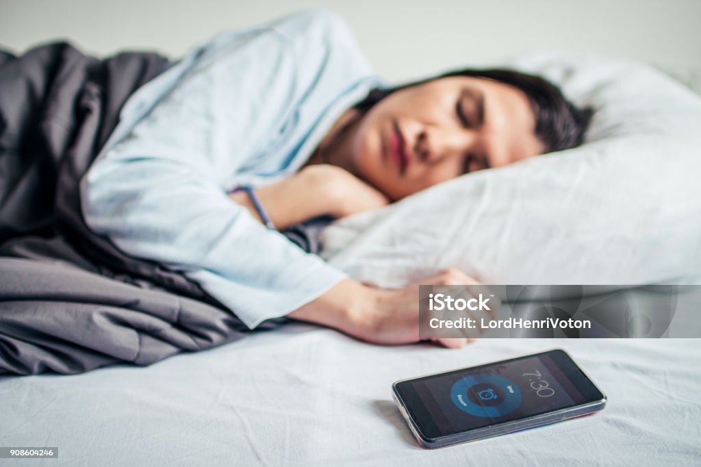 Woman Sleeping On Bed With Alarm On Mobile Phone Sleeping Stock Photo