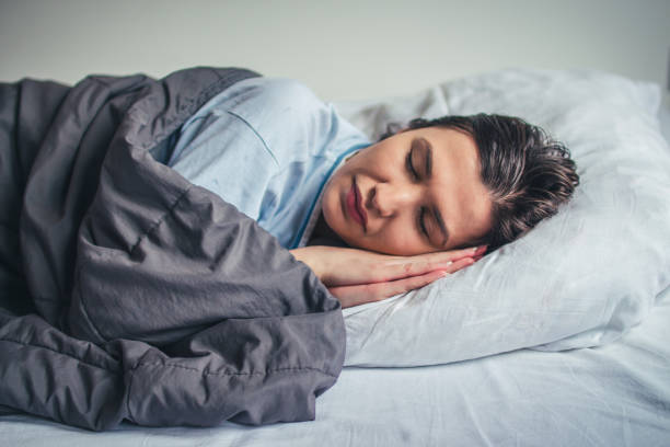 istock Young beautiful woman sleeping in her bed 908604566
