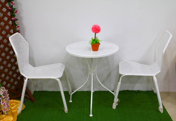 istock red flower in vase on a white table 908608128