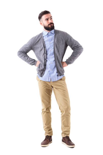 istock Handsome stylish bearded man thinking and looking up with arms on hips 908610368