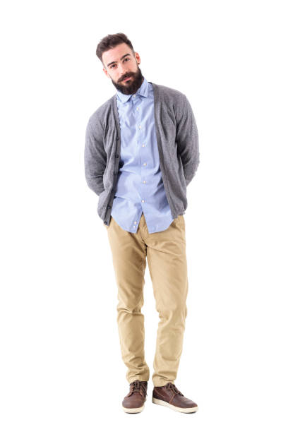 istock Cool relaxed smart casual guy in cardigan with hands behind leaning on side 908610628