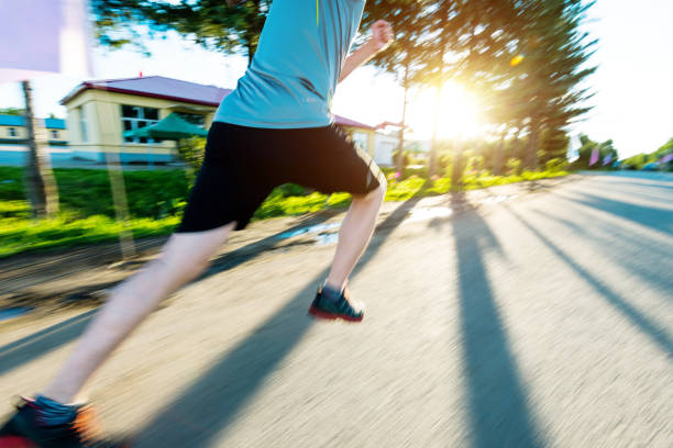 istock Man running in the park morning 908611336