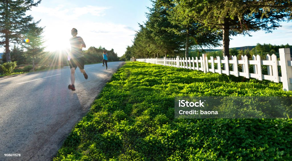 Father and son running in the park 30-39 Years Stock Photo