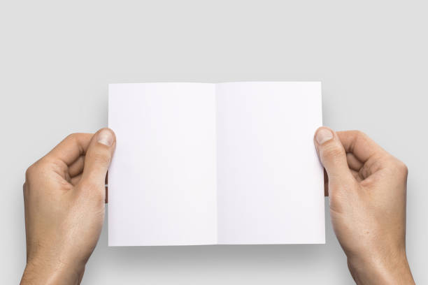 istock Empty white A6 postcard horizontally. Man holds a pattern in his hand on a gray background 908613962