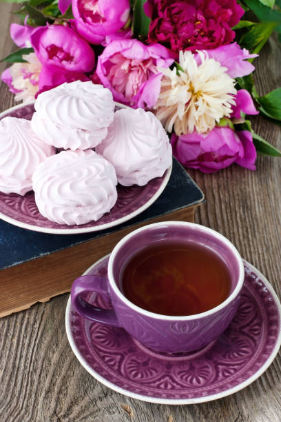 istock Composition with peonies , tea cup and zephyr cookies 908613972