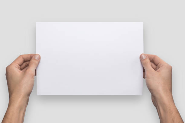 istock Mockup A4 letter horizontally empty blank white holds the man in his hand. Isolated on a gray background 908617676