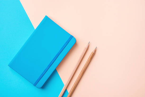 istock Writing Notepad Wood Pencils on Contrast Blue Peach Pink Pastel Color Background Combination. Business Education Routine Organization Planning Concept. Elegant Style Copy Space 908626114