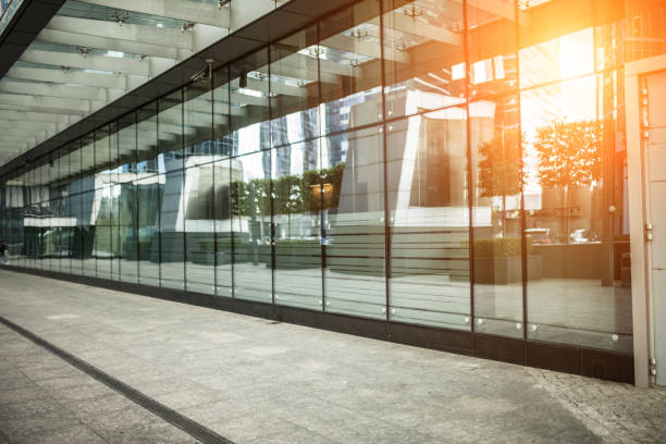istock modern city street footpath with glass windows wall and sunlight 908629740