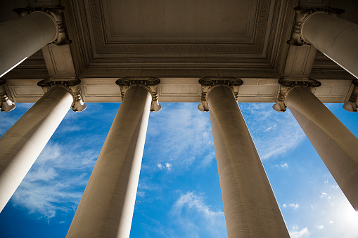 Building column on a government building with a beautiful blue sky.