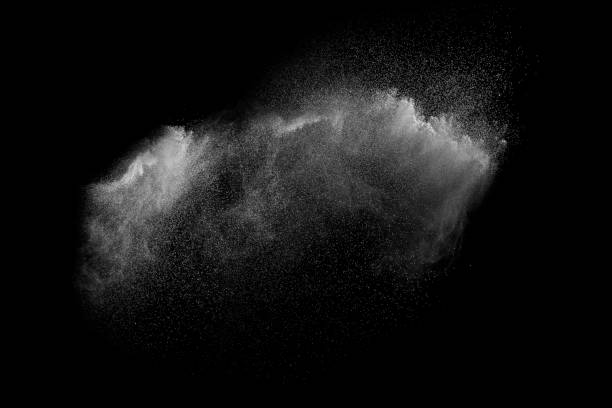 istock Freeze motion of white particles on black background. White granule explosion. Abstract white dust overlay texture. 908636026