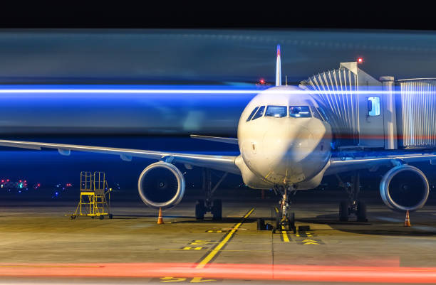 istock Modern white passenger airplane standing on parking place at night and get ready for boarding passengers in international airport Yekaterinburg. 908639756