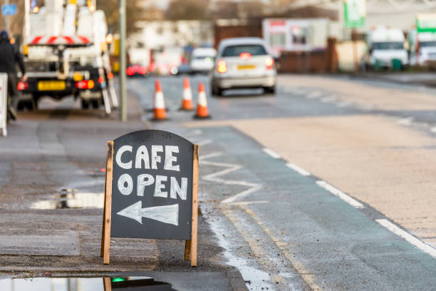 istock Day view Cafe Open wooden sign on sidewalk 908640016