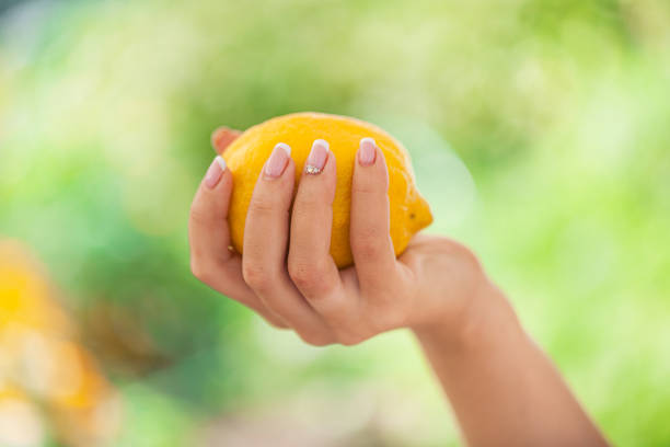 istock Woman keep lemon outdoor. Selective 908643650