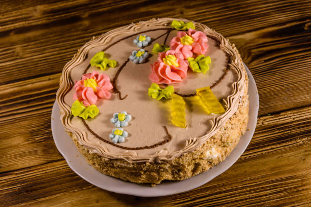 istock Kiev cake with cream on wooden table 908644212