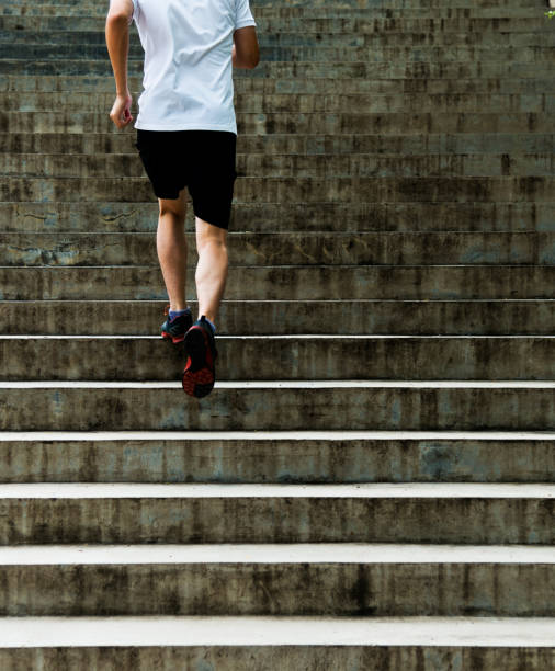 istock Man running up outdoor stairs 908647552