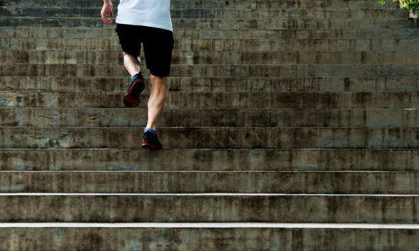 istock Man running up outdoor stairs 908647610