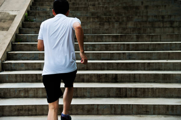 istock Man running up outdoor stairs 908647810