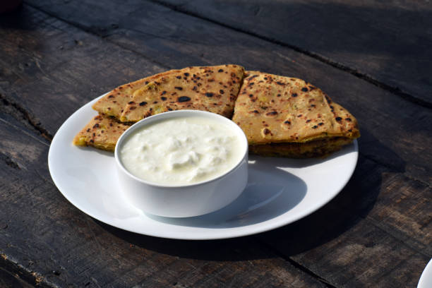 Paratha and curd Paratha and curd for breakfast placed on wooden curd cheese stock pictures, royalty-free photos & images