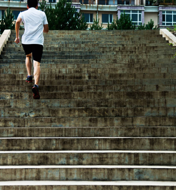 istock Man running up outdoor stairs 908647814