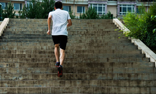 istock Man running up outdoor stairs 908647878