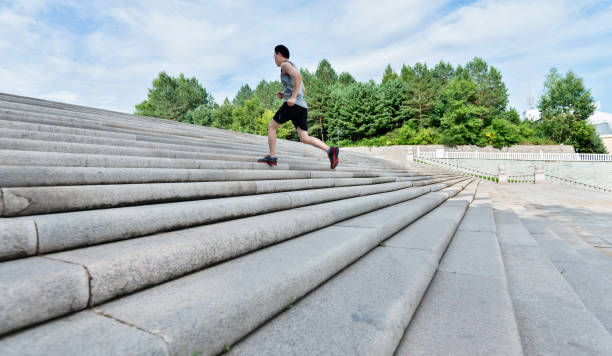 istock Man running up stone stairway 908650454