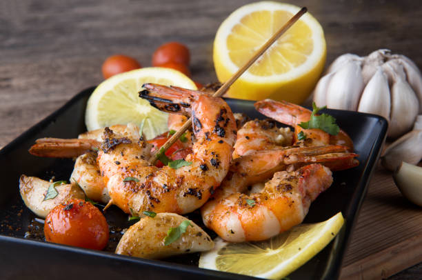 istock Skewers Barbeque grilled prawns with spicy ingredients. 908650938