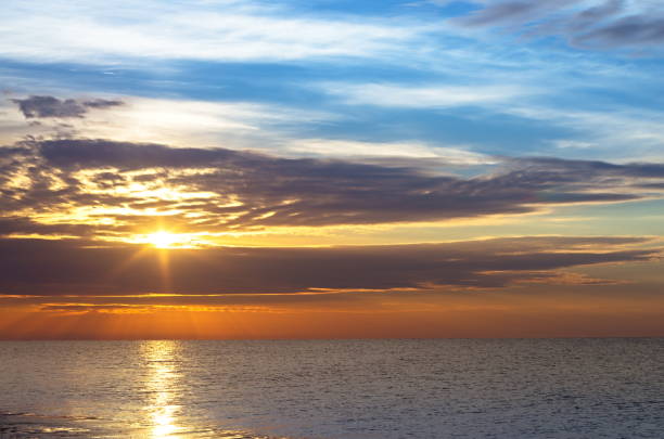 istock seascape, sunrise over the sea, sun clouds. 908651534