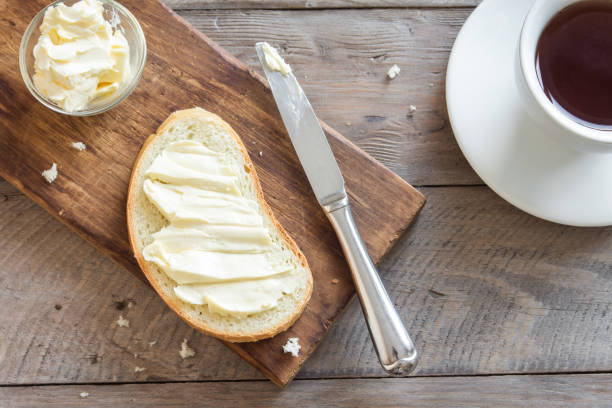 Bread, butter and coffee Butter and bread for breakfast, with cup of coffee over rustic wooden background with copy space. Morning breakfast with coffee, butter and toasts. margarine stock pictures, royalty-free photos & images