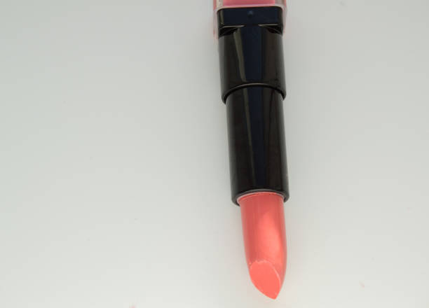 istock Pink lipstick, open the tube on a white background 908654424