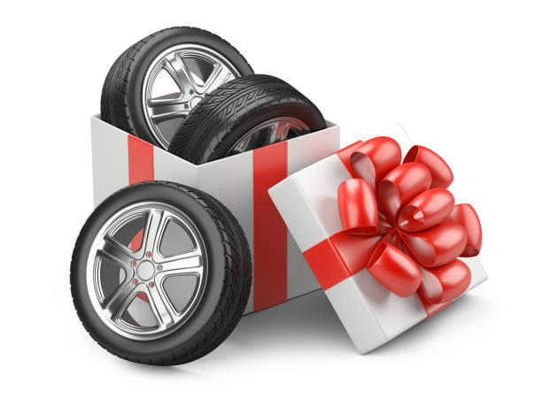 istock White open cardboard box gift with car tires whelles and red bow on a cap. 908655638