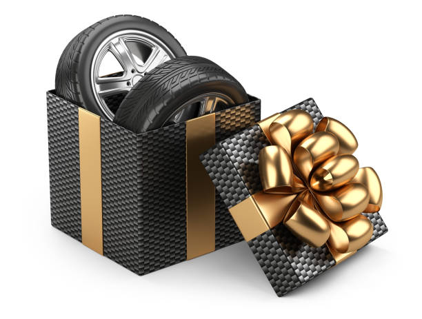 istock Black open cardboard box gift with car tires whelles and red bow on a cap. 908655722