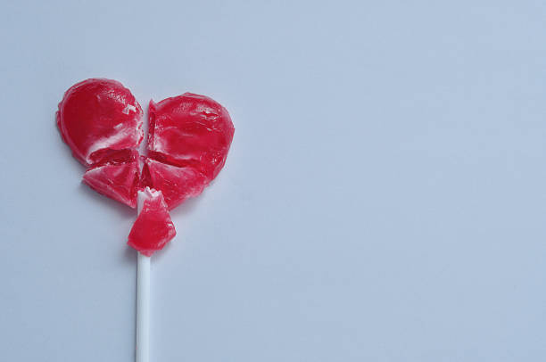 istock A broken red heart lollipop symbolizing a broken heart 908660732