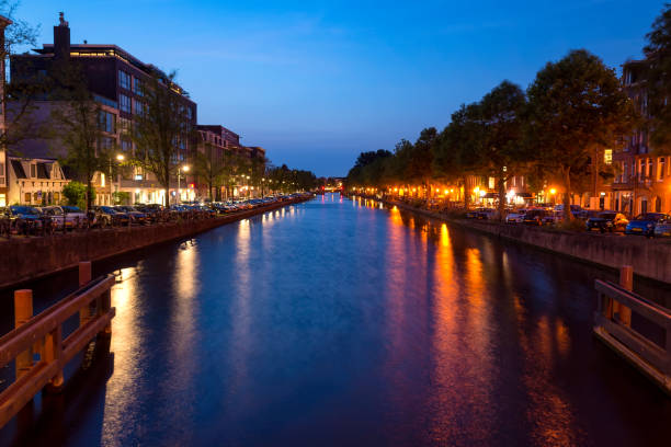 istock Amsterdam, Netherlands, 20 June 2017: Nighttime lights over the canals 908661304