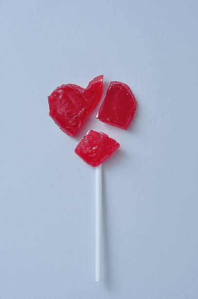 istock A broken red heart lollipop symbolizing a broken heart 908664122