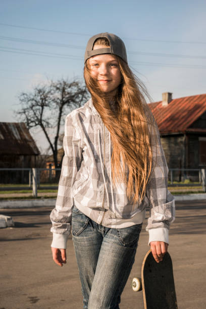 istock child girl with skateboard 908664866