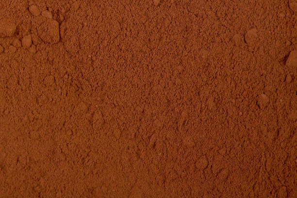 fondo de un cacao en polvo - polvo de cacao fotografías e imágenes de stock