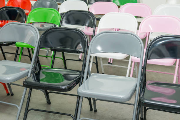 istock Rows of empty multicolor seats, chairs in auditorium, hall, classroom. Conference hall or seminar room. Selective focus. 908668182
