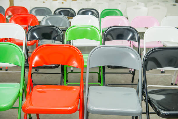 istock Rows of empty multicolor seats, chairs in auditorium, hall, classroom. Conference hall or seminar room. Selective focus. 908668200