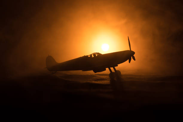 istock British jet-propelled model plane in possession. Dark orange fire background. War scene. 908671096