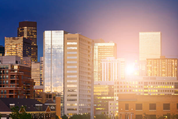 Denver Colorado downtown skyline buildings with the warm glow of sunlight shining through the skyscrapers