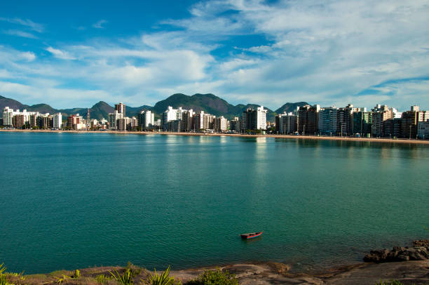 istock Coastline with mountains and buildings 908679670