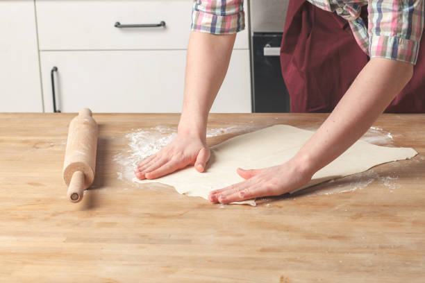 istock woman housewife baker hands cooking pastry with rustic rolling pin 908680020